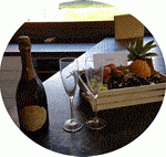 Pellet-shaped visual showing a fruit basket and champagne with 2 flutes at the Yellowstone Lodge.